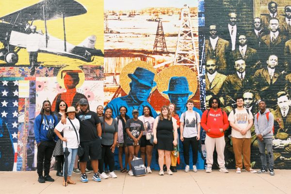 Group photo of OSLEP students in front of a mural in Black Wall Street in Tulsa, Oklahoma.